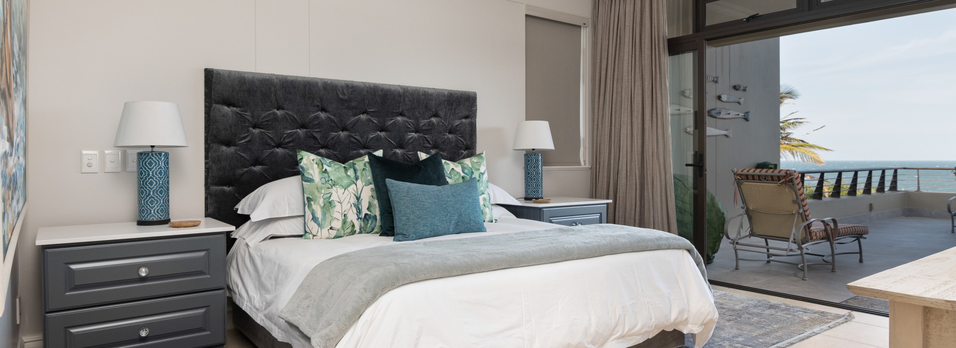 Main bedroom opening onto a terrace, the sea horizon running through the doorway