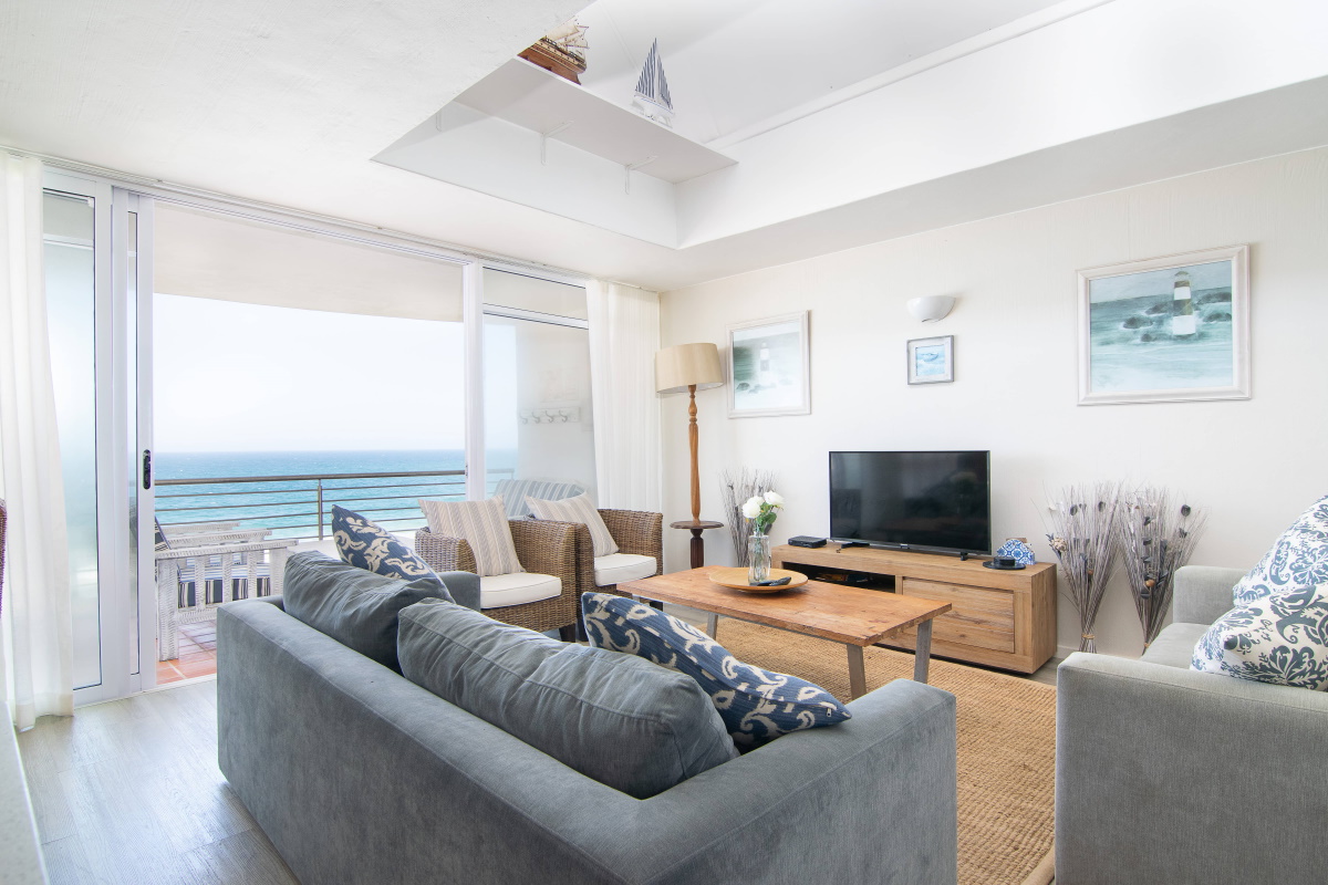 Salt Rock Sands 7 — airy lounge opening onto a sea-view balcony